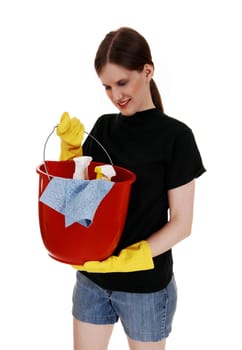 A young woman in shorts and yellow rubber cloves holding up an red.bucket ready for cleaning, for white background..