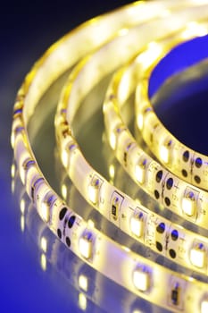 Macrodetail of a warm white LED strip in coloured light