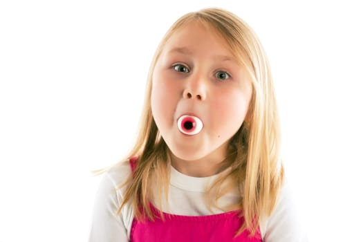 little girl with eye in her mouth. studio shot