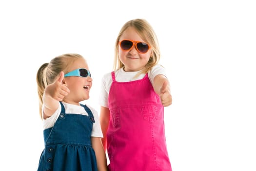 two little girls showing thumbs up. Studio shot.