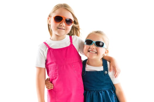 two happy little sisters isolated on white