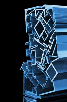 many different aluminium profile strips in blue spotlight