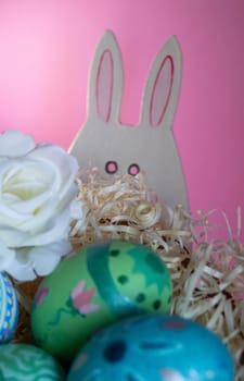 Flowers, Easter eggs and funny bunny to celebrate Easter. Space for text. Wallpaper for Easter announcements and cards.Vertical real picture, ideal for social media stories and postings