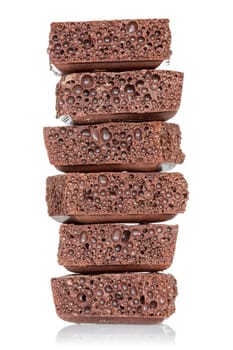 Stack of chocolate pieces on a white background