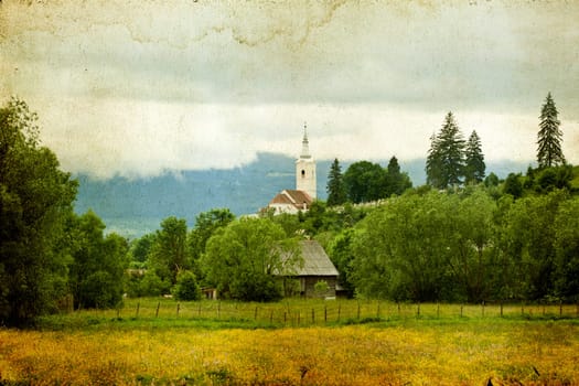 Old house in the mountains on the field