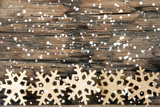 Golden Christmas Snowflakes on Wood with Snow