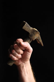 Hammer and a Hand on a Black Background