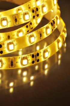 Macrodetail of a warm white LED strip in coloured light