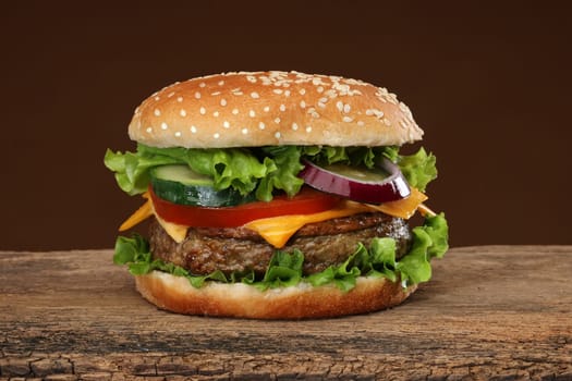 Tasty hamburger on wood background. Lots of ingredients