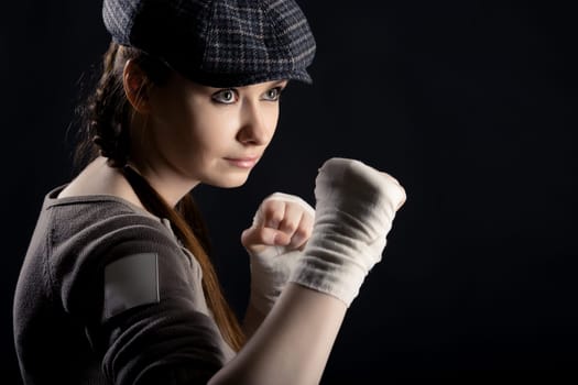 On a black background girl with a fighting stance