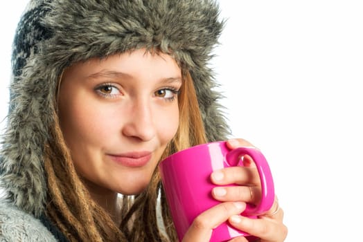 Blonde girl with fur hat holds coffee mug