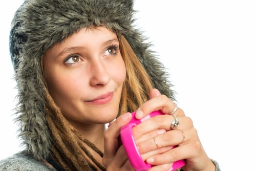 Blonde girl with fur hat holds coffee mug
