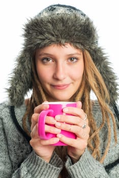 Blonde girl with fur hat holds coffee mug