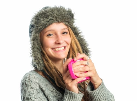 Blonde girl with fur hat holds coffee mug
