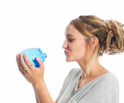 Blonde girl holds a piggy bank