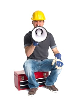A craftsman sits on a toolbox and holds a megaphone