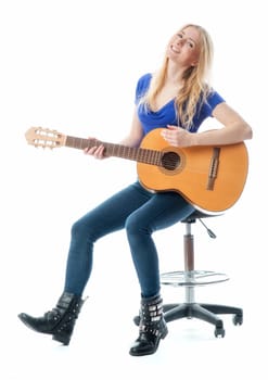 Blonde girl playing on a guitar
