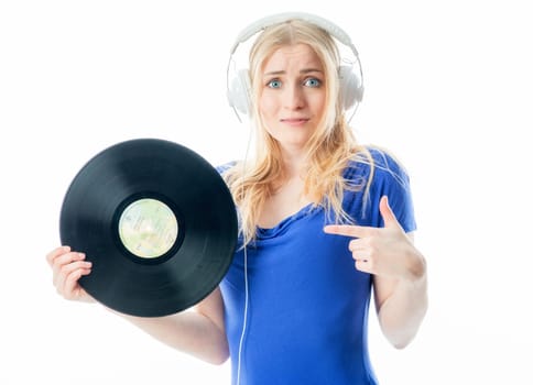 Blonde girl with headphones holds a record and a CD
