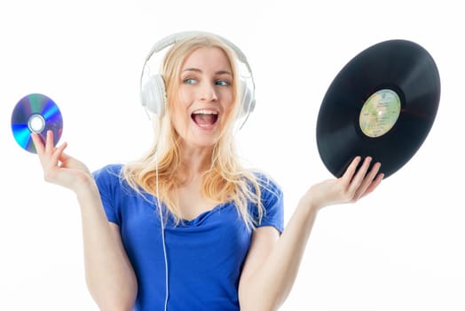 Blonde girl with headphones holds a record and a CD