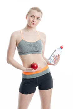 Blonde sportswoman with drink and apple
