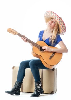 Blonde girl with suitcase and guitar