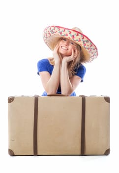 Blonde girl sits behind a suitcase