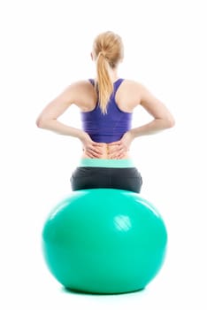 Blonde girl sits on the Pezziball