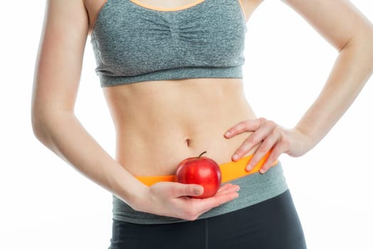 Blonde sportswoman with drink and apple