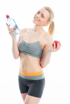 Blonde sportswoman with drink and fruit