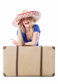 Blonde girl sits behind a suitcase