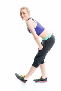 Blonde athlete does fitness exercises