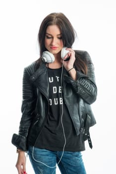 Woman in leather jacket wears headphones