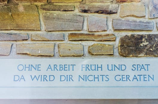 Inscription on the entrance to the house with a wise saying.