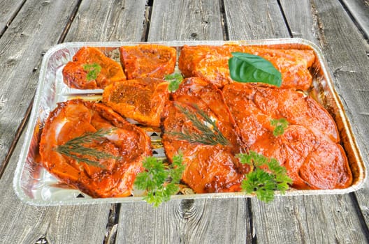 Grilled meat,grilled meat marinated in an aluminium bowl.