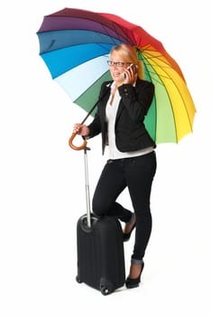 Businesswoman with suitcase and umbrella on the phone