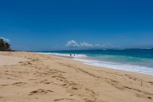 Beautiful secluded sandy beach in the Caribbean with white sand and blue sky as in paradise