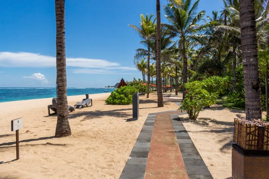 Tropical beach with sun lounger and umbrellas with white sand in the Caribbean