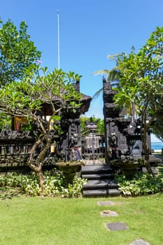 Stairs on a stone wall to an entrance to a house in Bali