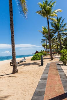 Tropical beach with sun lounger and umbrellas with white sand in the Caribbean