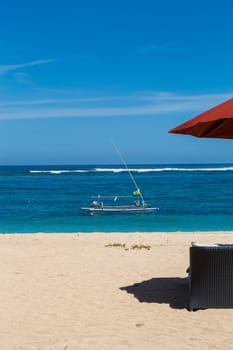 Tropical beach with sun lounger and umbrellas with white sand in the Caribbean