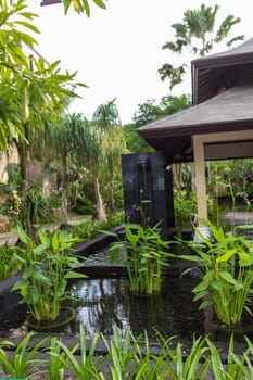 Artful carvings in stone stonemasonry in a green complex in Bali