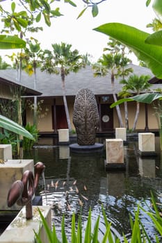 Artful carvings in stone stonemasonry in a green complex in Bali