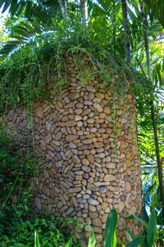 Artful carvings in stone stonemasonry in a green complex in Bali