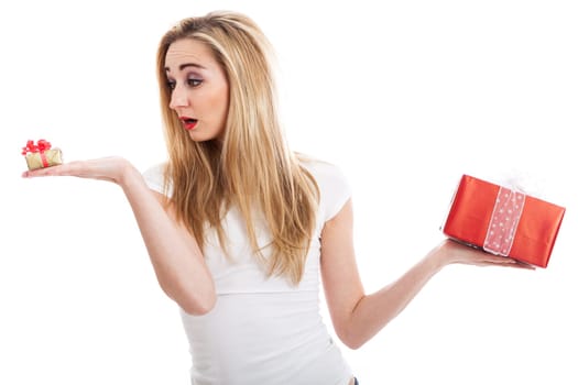 Young attractive woman with gifts rejoices and laughs isolated against white background