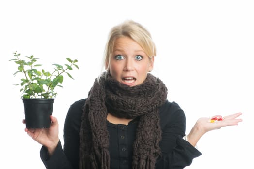 Woman with medicinal plant and capsules