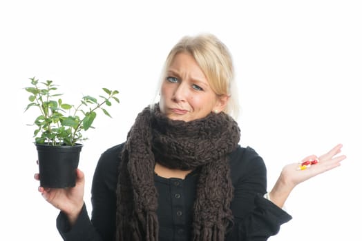 Woman with medicinal plant and capsules