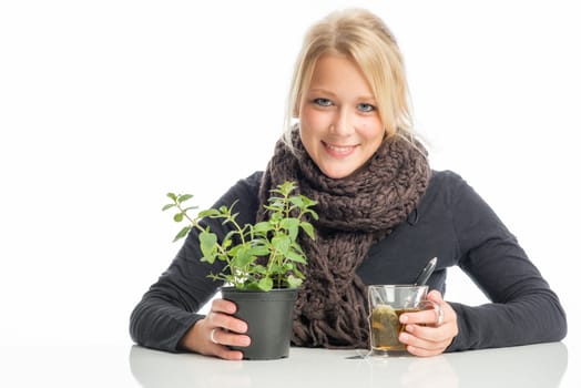 Sick blonde woman drinks herbal tea