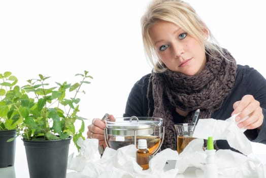 Sick blonde woman drinks herbal tea