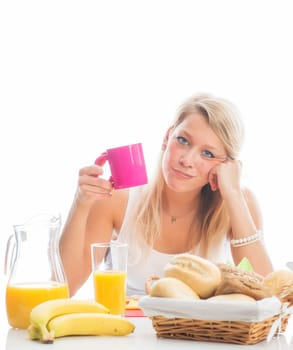 Blonde woman sits at the covered breakfast table
