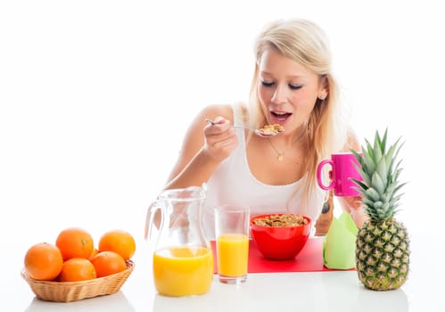 Blonde woman spoons cornflakes